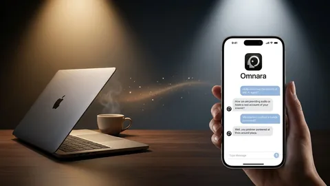 Phone showing a chat app interface beside an open laptop